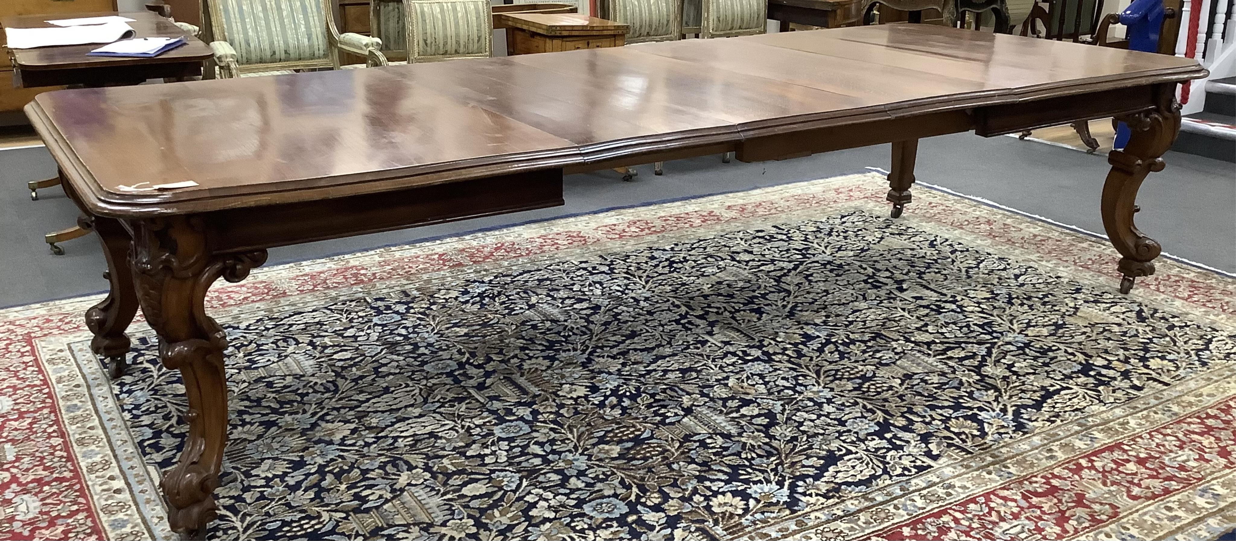 A Victorian oak extending dining table on carved cabriole legs, width 320cm extended, three spare leaves, depth 128cm, height 77cm. Condition - fair